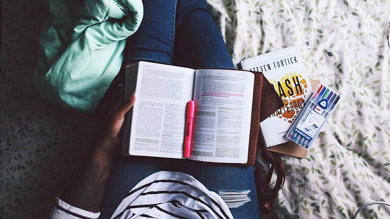 Girl highlighting her textbook