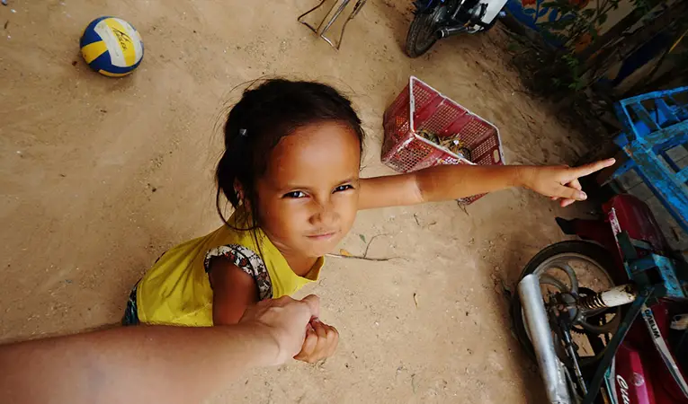 Cambodian girl grabbing photographers hand