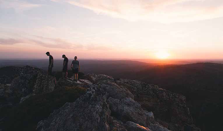 Sunrise hike, three high school students on a mountain