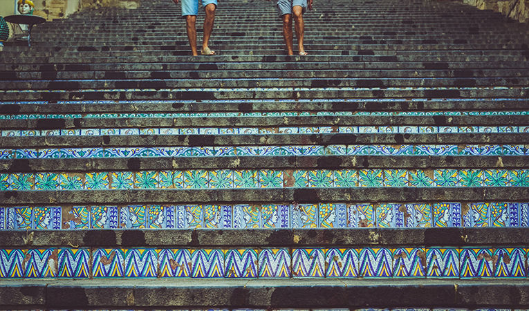 Walking down bright turquoise mosaic steps in Caltagirone, Italy