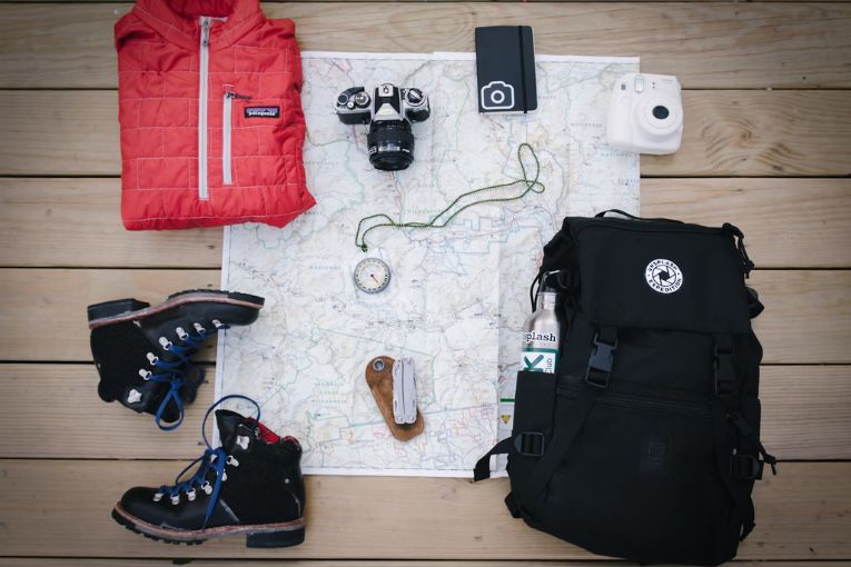 backpacking gear with map on the floor