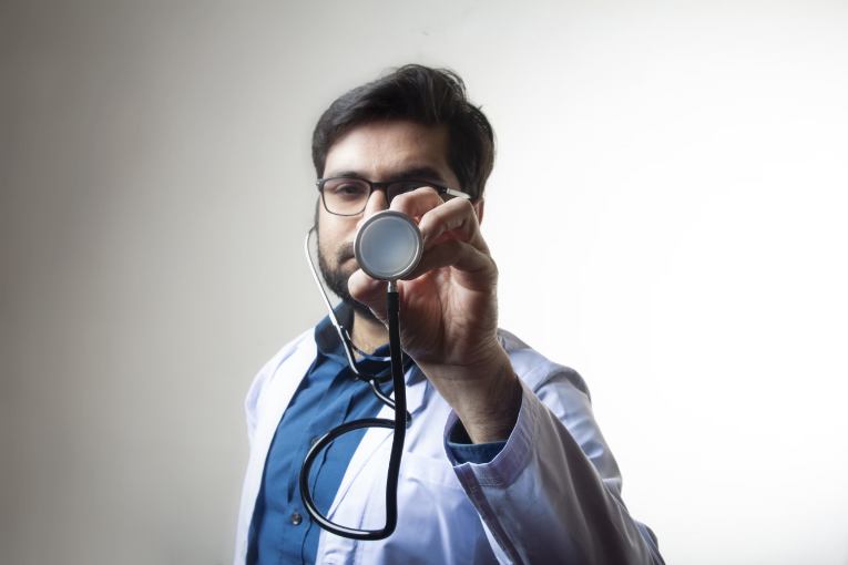 person holding up stethoscope in front of face