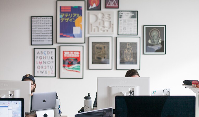 workspace with two people working at computers