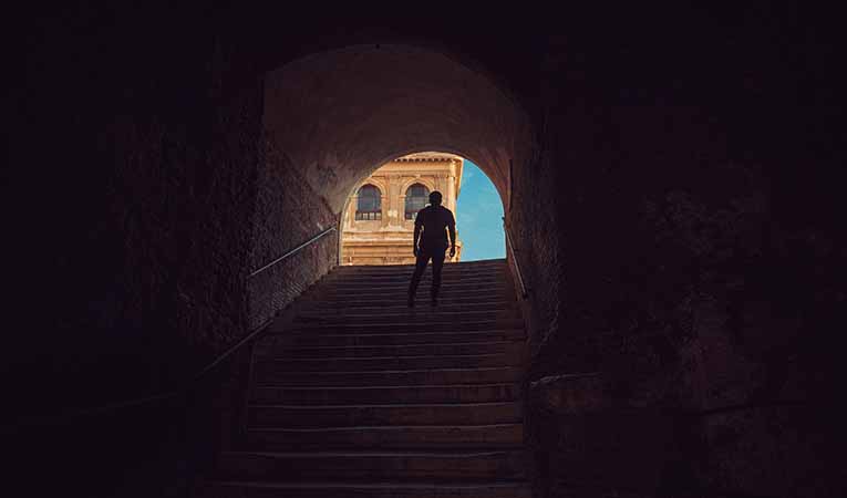 boy climbing stairs in Italy
