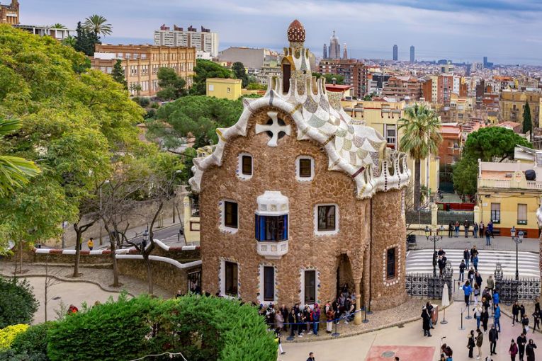 building at the front of park guell in spain