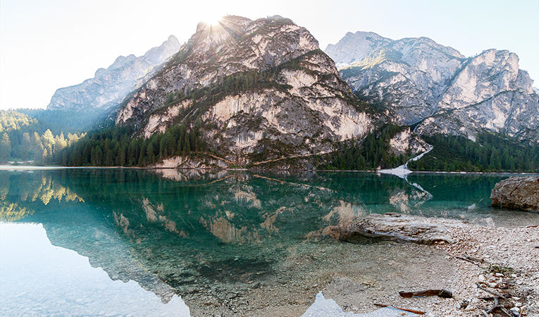 Mountain, crystal clear lake, sun flare, Tyrol, Italy