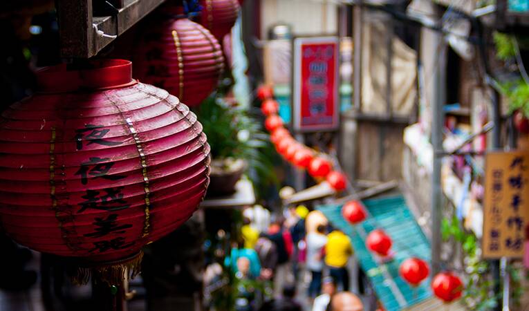 Red chinese lanterns hanging from a balcony