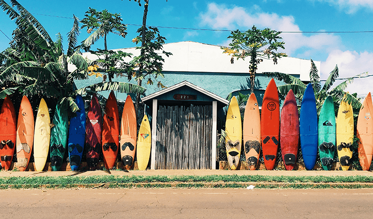 Surfboards lined up along fence in Costa Rica