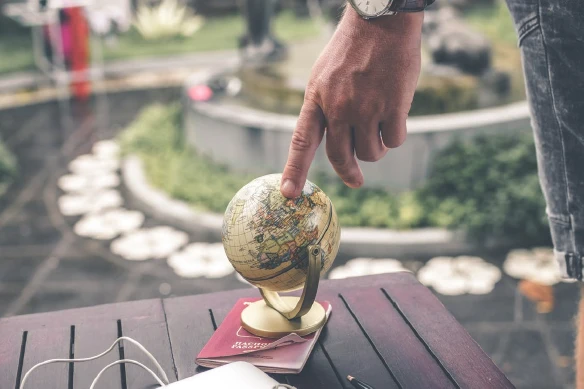 finger touching the globe